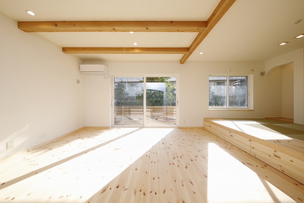 パインの無垢材の床。梁現しのリビング。リビングの先にはウッドデッキが広がります。<br />
